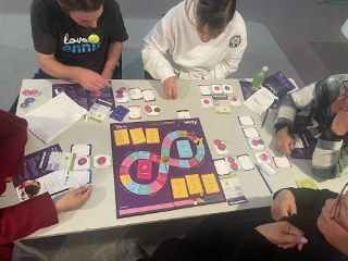 People playing the Haumi e! boardgame