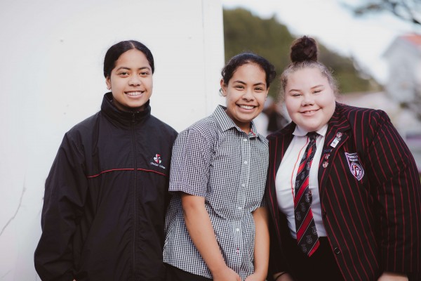 Three Glenfield College students smiling